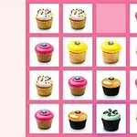 Barevné muffiny uspořádané do mřížky se ztraceným jedním místem na růžovém pozadí