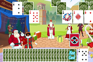 Vánoční scéna s kartami, na které jsou zobrazeni Santa Claus, osoba v červených šatech a hromada dárků