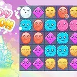 Barevná mřížka s roztomilými tvářemi a logem Cloudy Kingdom vedle kresleného hradu na pastelovém pozadí