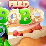 Zelený kreslený drak s brýlemi před dortem se slovy Feed Bobo zobrazenými nahoře
