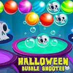 Barevné bubliny na tmavě modrém pozadí s lebkami a nápisem Halloween Bubble Shooter