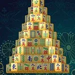 Pyramida z mahjongových kamenů s různými symboly na tmavém pozadí s květinovým vzorem