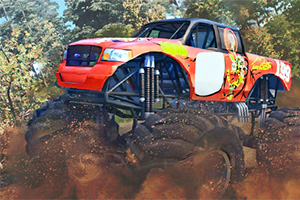 Velký červený monster truck projíždí blátivou stezkou v lesním prostředí