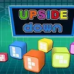Barevné kostky s digitálními displeji na zeleném mřížkovaném pozadí s nápisem Upside Down v horní části